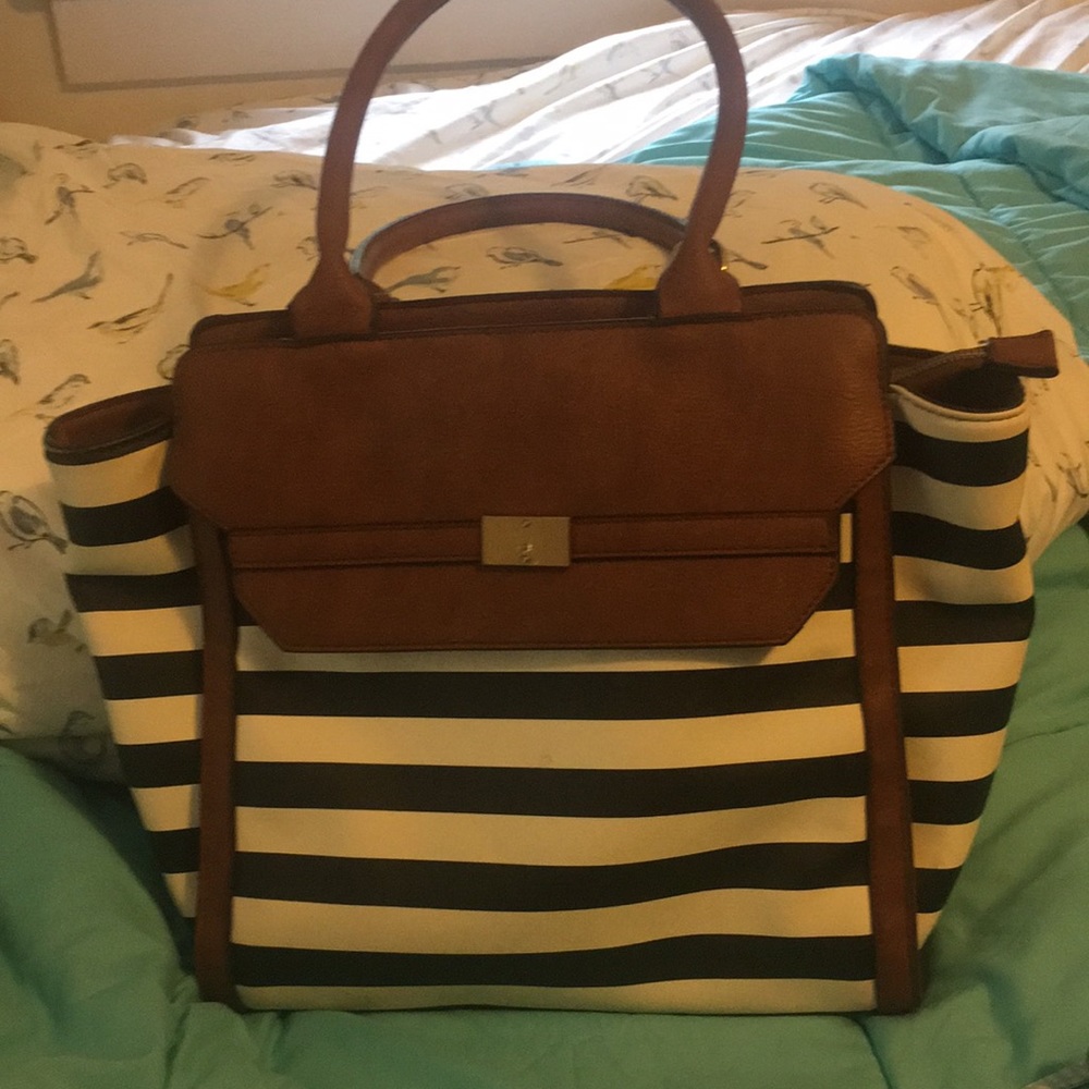 Blue and white striped pocketbook, brown straps and accents, anchor interior.